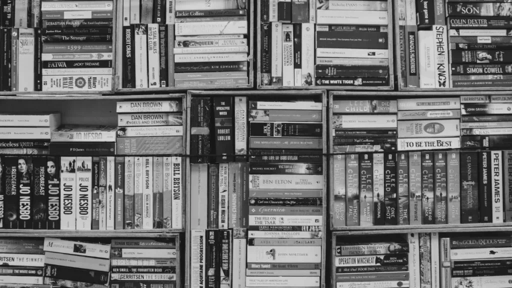 Full bookshelf packed with books, representing research, reading, and resource gathering for a unit of learning.