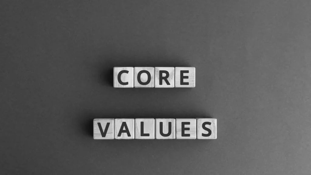Wooden blocks spelling core values, representing the values families should consider before home educating.